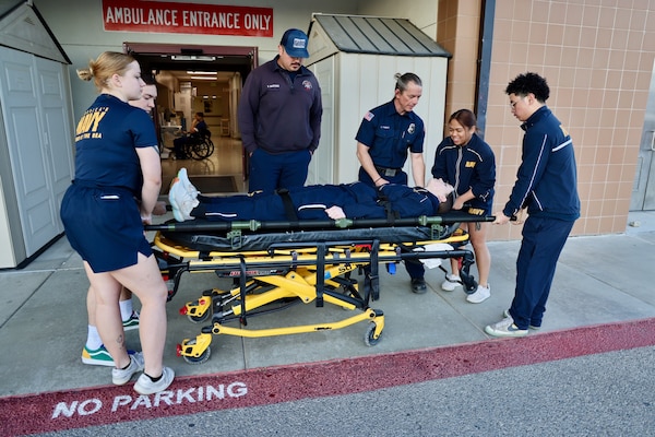Hospital corpsmen assigned to the Multi-Service Unit at Naval Hospital Twentynine Palms participate in Tactical Combat Casualty Care (TCCC) training alongside the Marine Corps Air Ground Combat Center Fire Department on March 21. The hands-on exercise reinforced critical trauma response skills, ensuring corpsmen are prepared to provide life-saving care in mass casualty and combat scenarios (U.S. Navy photo by Christopher C. Jones, NHTP/NMRTC Twentynine Palms public affairs officer).