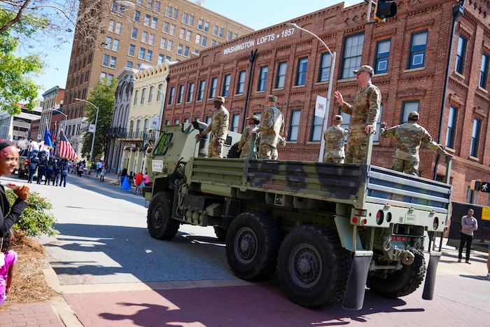 An LMV carries service members from Robins Air Force, Georgia, down Mulberry Street during the 2025 International Cherry Blossom Festival in Macon, Georgia,
