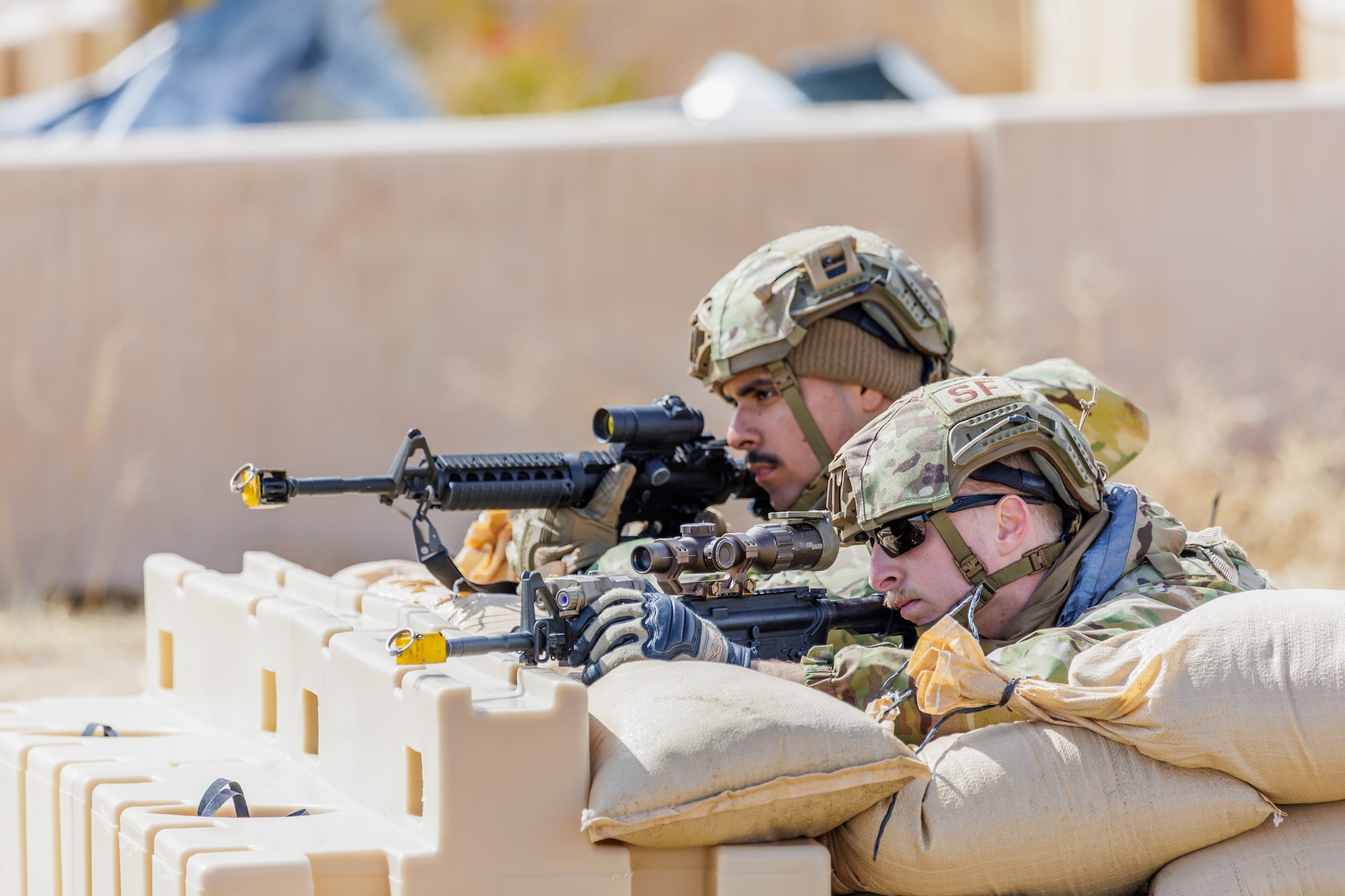 Senior Airman Hernan Bahena, 88th Security Forces Squadron, and Staff Sgt. Grant Baker, 412th SFS, secure their area during the 412th Security Forces Squadron’s Advanced Combat Training Exercise at Edwards Air Force Base, California, March 14. (Air Force photo by James West)