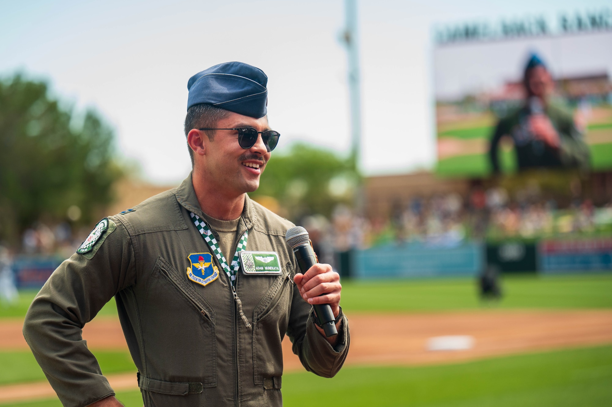 U.S. Air Force Capt. Adam Munekata, 308th Fighter Squadron student pilot, yells the ceremonial “Play Ball!” at the 2025 Military Appreciation game, Mar. 23, 2025 at the Camelback Ranch baseball complex, Glendale, Arizona.