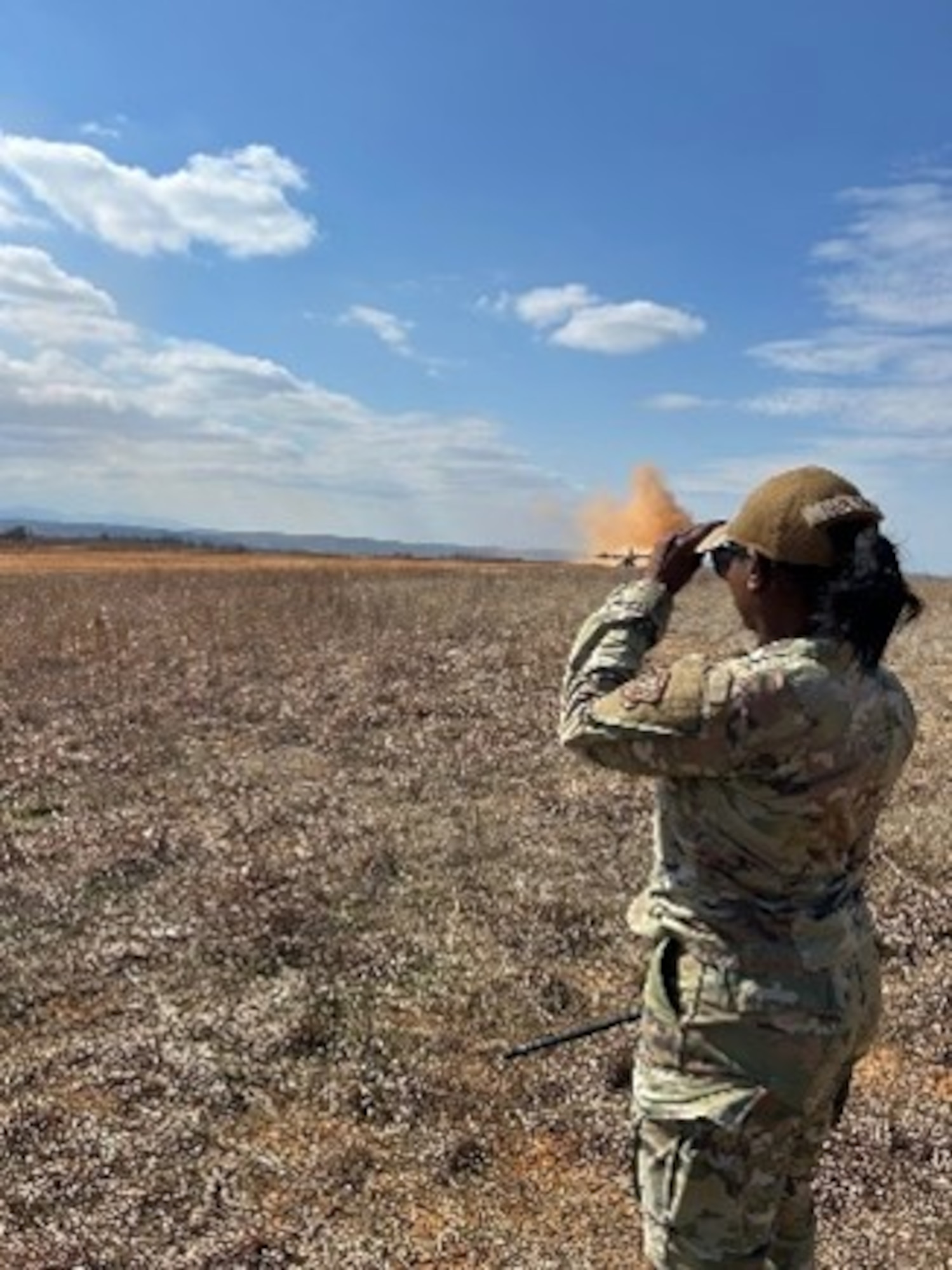 Senior Airman Yakini Gardner, 22nd Operations Support Group air traffic controller, watches aircraft land after giving coordinates during the Landing Zone Qualification Course Feb. 26, 2025, at Little Rock Air Force Base, Arkansas. During the four-day course, the Airmen identified suitable locations critical to ensuring aircraft can land and take off safely, especially in environments where traditional airfields are unavailable. They also learned how to assess potential landing zones by evaluating terrain, size, and safety considerations. (U.S. Air Force photo by Staff Sgt. Enrique Guzman)