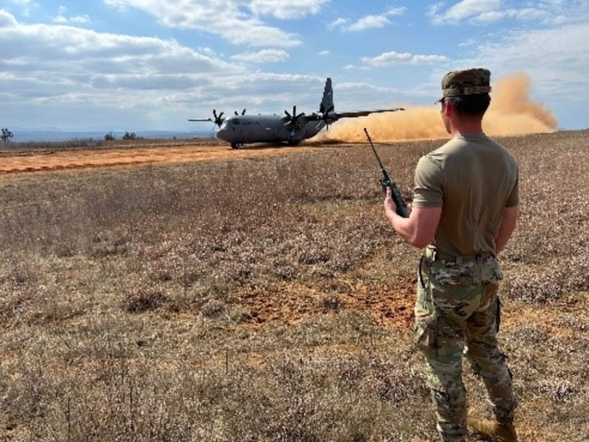 Airman 1st Class Isaiah Schlechte, 22nd Operations Support Squadron air traffic controller, helps coordinate the landing of an aircraft during the Landing Zone Qualification Course Feb. 26, 2025, at Little Rock Air Force Base, Arkansas. During the four-day course, the Airmen identified suitable locations critical to ensuring aircraft can land and take off safely, especially in environments where traditional airfields are unavailable. They also learned how to assess potential landing zones by evaluating terrain, size, and safety considerations. (U.S. Air Force photo by Staff Sgt. Enrique Guzman)