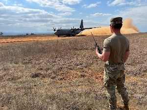 Airman 1st Class Isaiah Schlechte, 22nd Operations Support Squadron air traffic controller, helps coordinate the landing of an aircraft during the Landing Zone Qualification Course Feb. 26, 2025, at Little Rock Air Force Base, Arkansas. During the four-day course, the Airmen identified suitable locations critical to ensuring aircraft can land and take off safely, especially in environments where traditional airfields are unavailable. They also learned how to assess potential landing zones by evaluating terrain, size, and safety considerations. (U.S. Air Force photo by Staff Sgt. Enrique Guzman)