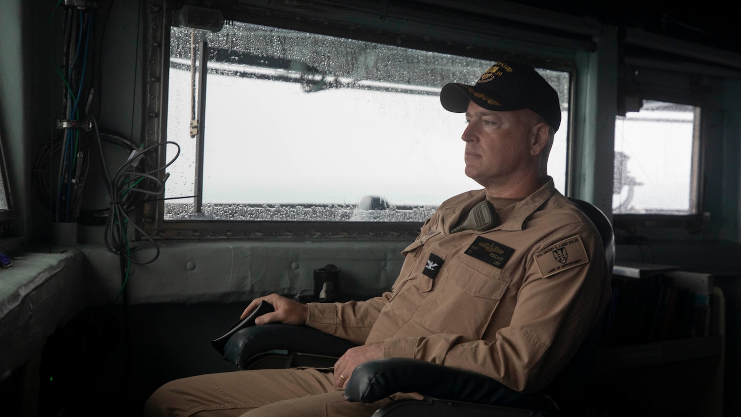 DARWIN, Northern Territory, Australia (Mar. 25, 2025) – Capt. Kenneth Holland, commanding officer of the submarine tender USS Emory S. Land (AS 39), observes from the bridge as the ship arrives in Darwin, Northern Territory, Australia for a regularly scheduled port visit, Mar. 25, 2025. Darwin is Emory S. Land’s 17th port call since it departed on deployment May 17, 2024. Emory S. Land is on deployment supporting the U.S. 7th Fleet, the U.S. Navy’s largest forward deployed numbered fleet, operating with allies and partners in preserving a free and open Indo-Pacific region. (U.S. Navy photo by Mass Communication Specialist 1st Class Ian Zagrocki)