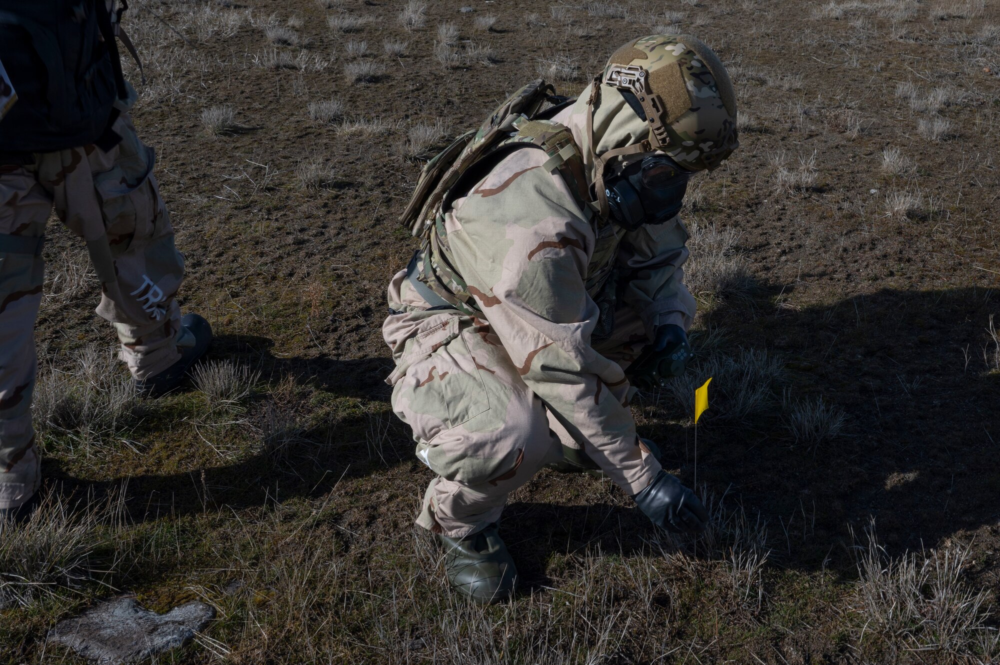 U.S. Air Force Airman 1st Class Kenneth Armstead, an emergency management specialist assigned to the 92nd Civil Engineer Squadron, places a flag into the mock contamination control area during training at Fairchild Air Force Base, Washington, Feb. 22, 2025. These flags identified contaminated areas within the five-point survey. (U.S. Air Force photo by Airman 1st Class Samantha Thorn)