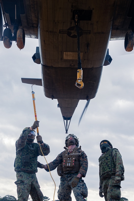 U.S. Marine Corps Cpl. Riley Wharton, a logistics specialist with Combat Logistic Company Bravo, Combat Logistics Battalion 31, 31st Marine Expeditionary Unit, center, and Japan Ground Self-Defense Force members with 1st Amphibious Rapid Deployment Regiment, prepare to attach a sling during an external lift exercise in support of Iron Fist 25, at Camp Hansen, Okinawa, Japan, Feb. 22, 2025. Iron Fist is an annual bilateral exercise designed to increase interoperability and strengthen the relationships between the U.S Marine Corps, U.S. Navy and Japan Ground Self-Defense Force. The 31st Marine Expeditionary Unit, the Marine Corps’ only continuously forward deployed MEU, provides a flexible and lethal force, ready to perform a wide range of military operations as the premier crisis response force in the Indo-Pacific region. Wharton is a native of Texas. (U.S. Marine Corps photo by Lance Cpl. Raul Sotovilla)