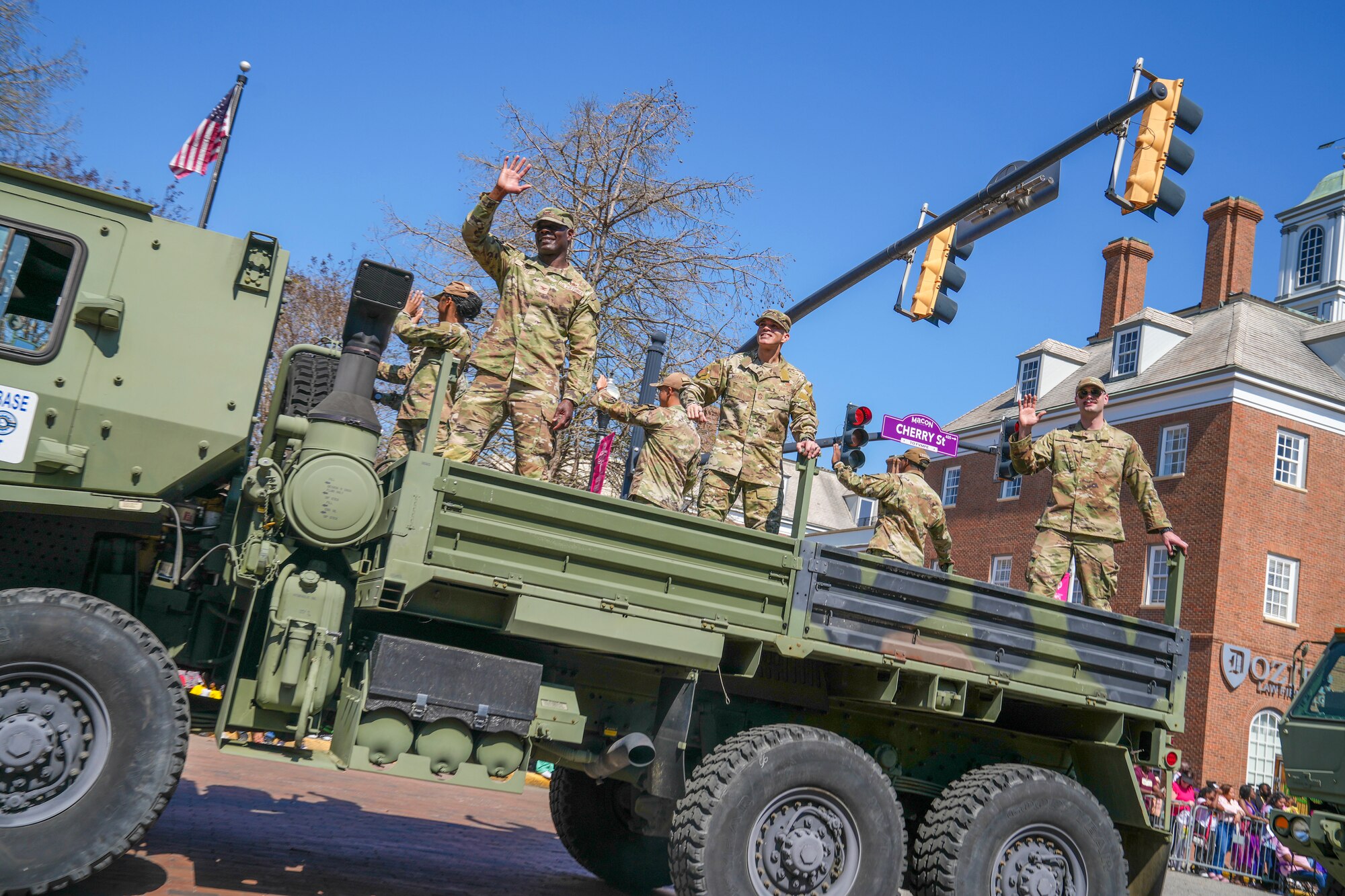Col. Deedrick Reese, left, and Chief Master Sgt. Lloyd Morales, center, greet spectators at the 2025 International Cherry Blossom Festival in Macon, Georgia, March 23, 2025.
