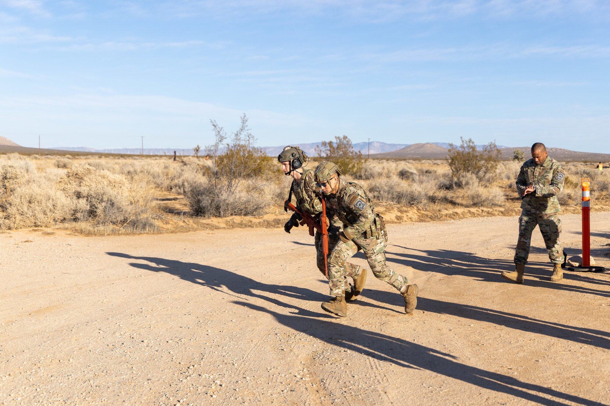 Staff Sgt. Parker Smith, out of Joint Base McGuire-Dix-Lakehurst, New Jersey, Staff Sgt. Ratha Lay, 436th Security Forces Squadron, of Dover Air Force, Delaware, begin their run during the 412th Security Forces Squadron’s Advanced Combat Training Exercise at Edwards Air Force Base, California, March 10 (Air Force photo by Daniel Kelley)