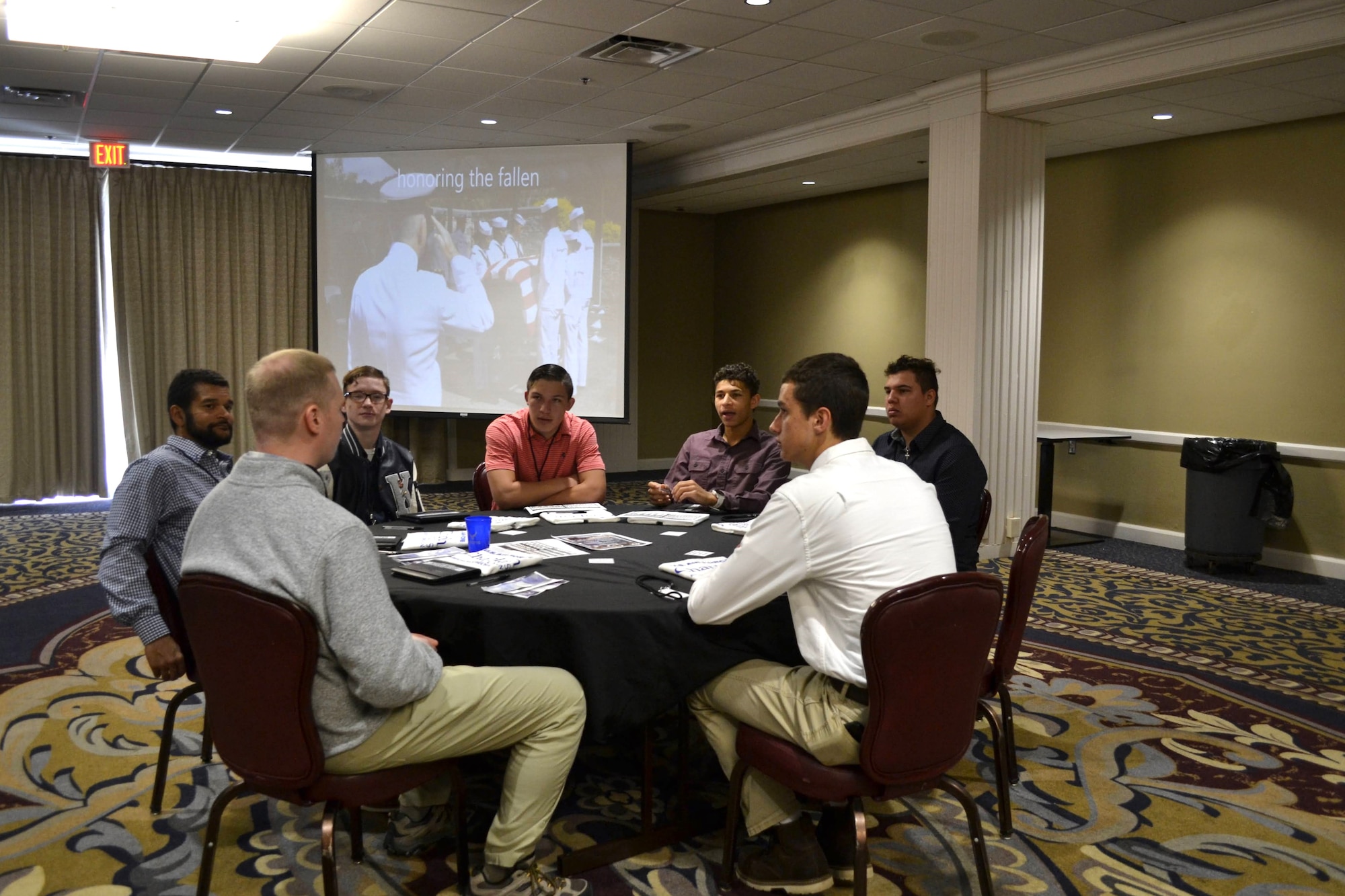 Group of men talking at table