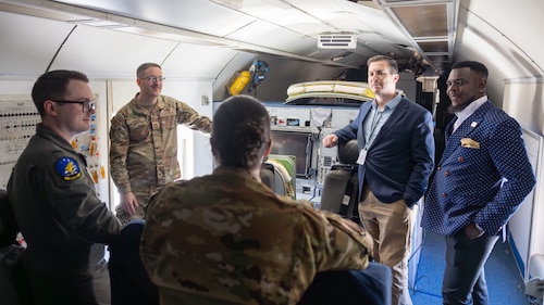 Group of people talking on military aircraft