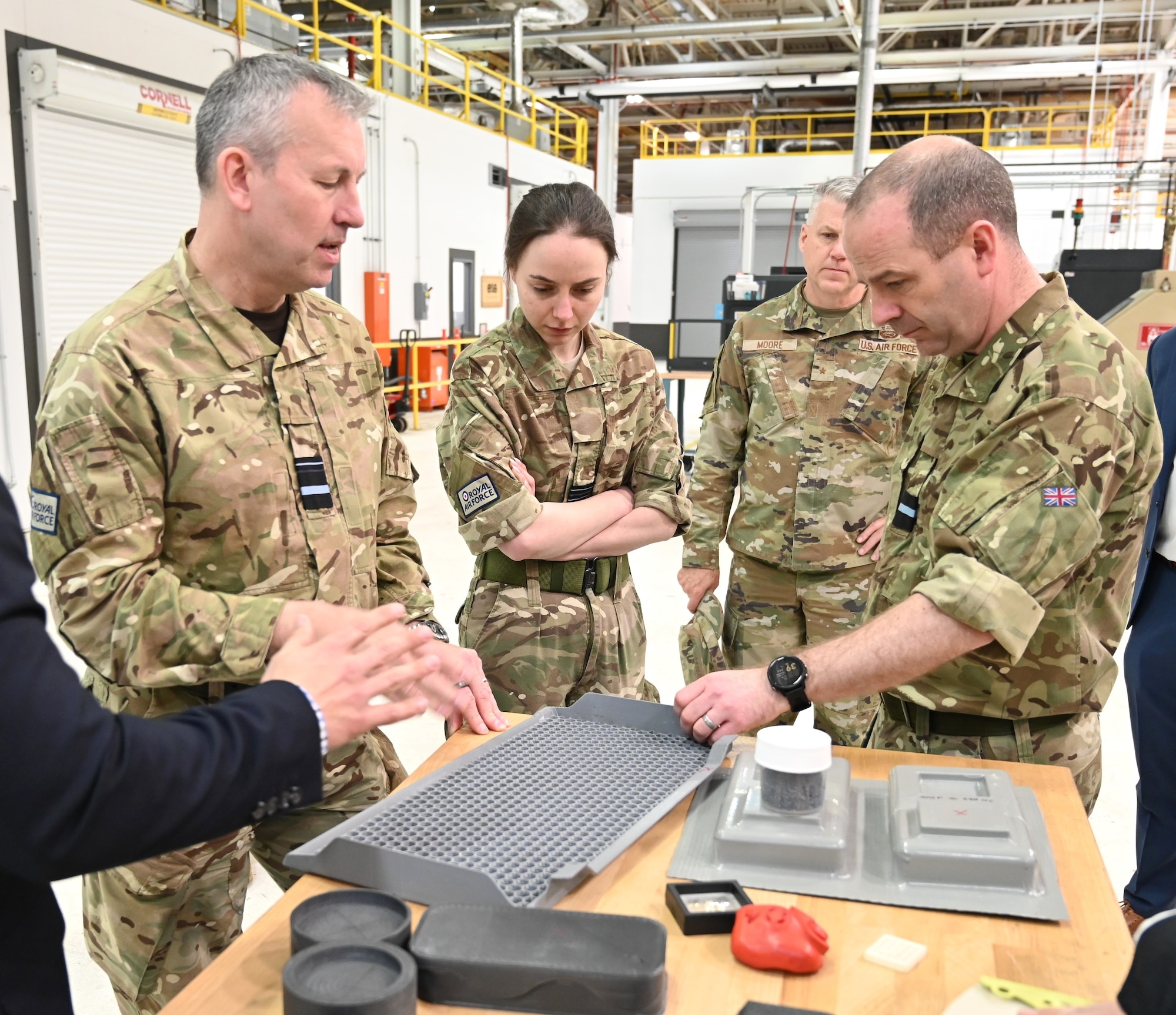 4 people admiring 3D equipment parts