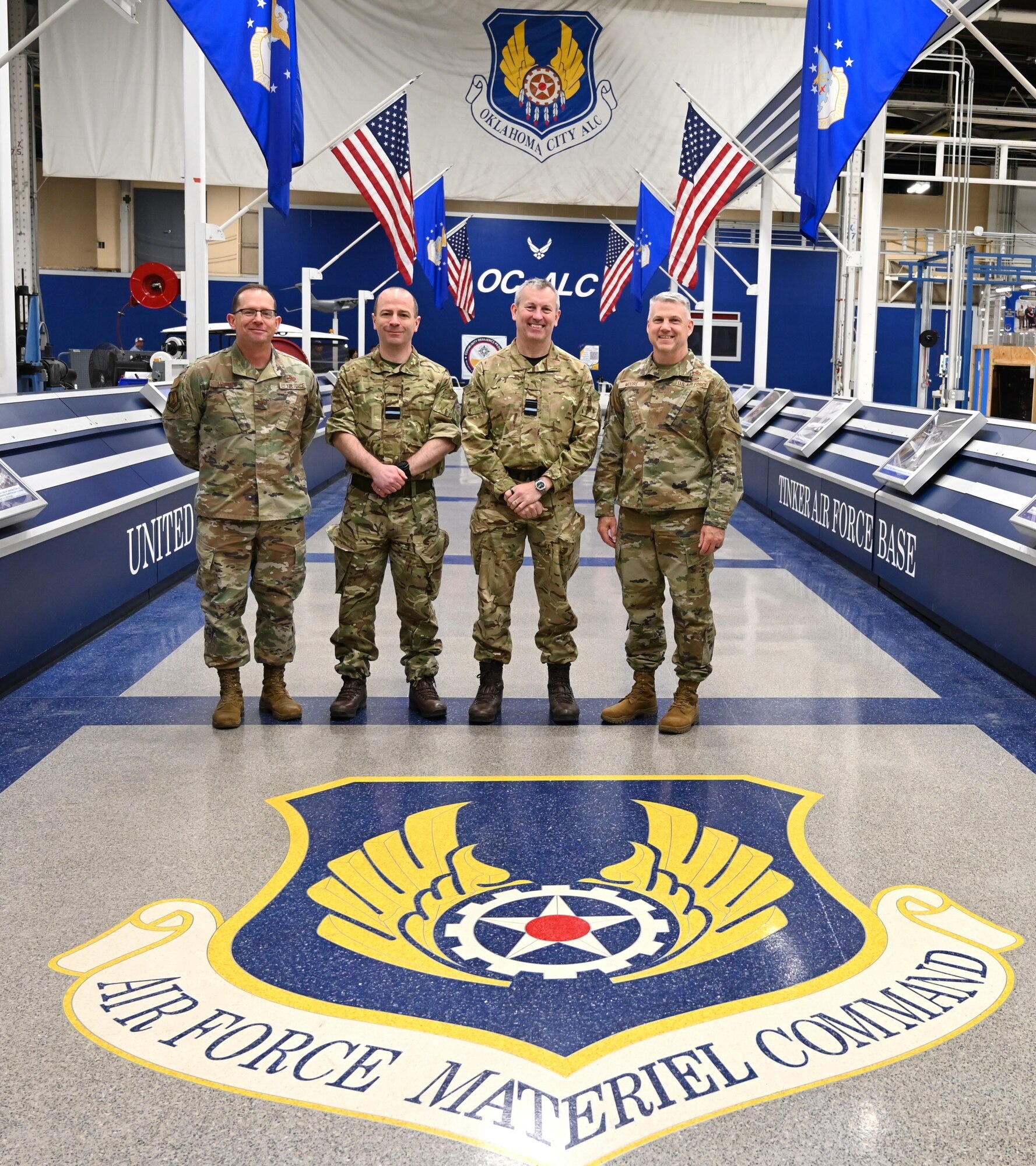 4 men standing next to each other in military uniforms