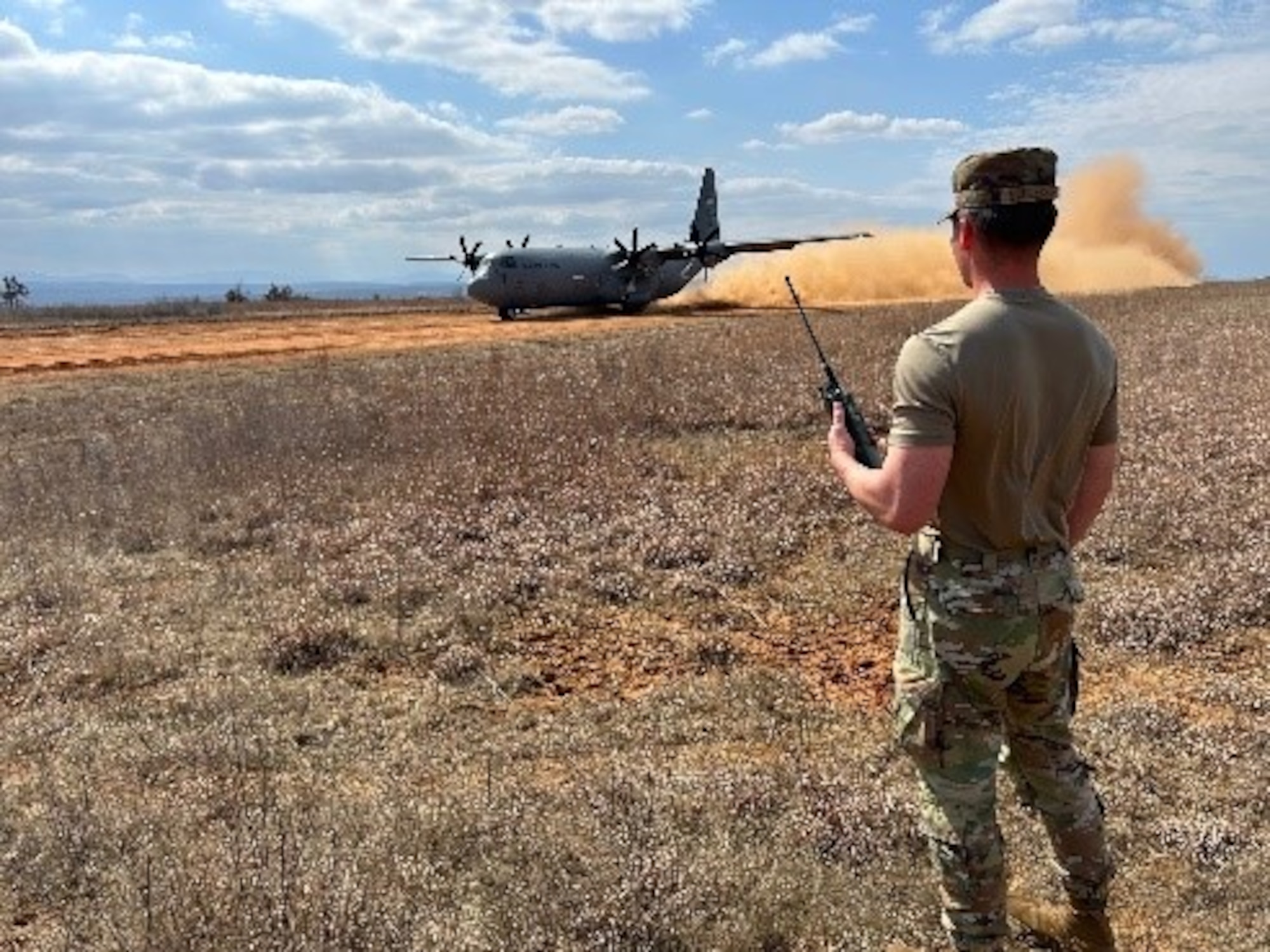 Airman 1st Class Isaiah Schlechte, 22nd Operations Support Squadron air traffic controller, helps coordinate the landing of an aircraft during the Landing Zone Qualification Course Feb. 26, 2025, at Little Rock Air Force Base, Arkansas. During the four-day course, the Airmen identified suitable locations critical to ensuring aircraft can land and take off safely, especially in environments where traditional airfields are unavailable. They also learned how to assess potential landing zones by evaluating terrain, size, and safety considerations. (U.S. Air Force photo by Staff Sgt. Enrique Guzman)