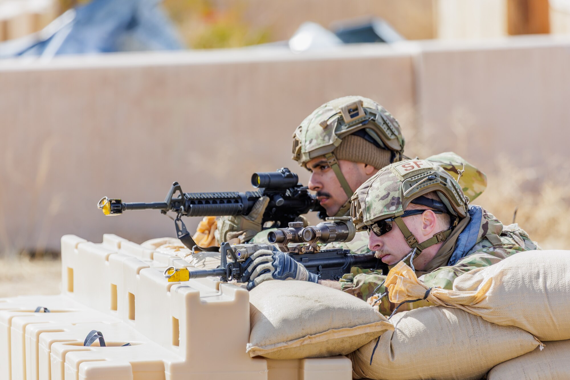 Senior Airman Hernan Bahena, 88th Security Forces Squadron, and Staff Sgt. Grant Baker, 412th SFS, secure their area during the 412th Security Forces Squadron’s Advanced Combat Training Exercise at Edwards Air Force Base, California, March 14. (Air Force photo by James West)