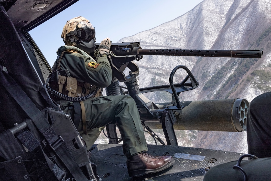 U.S. Marine Corps Cpl. Tristan Walker, a helicopter crew chief with Marine Light Attack Helicopter Squadron (HMLA) 267, Marine Aircraft Group 36, 1st Marine Aircraft Wing, sights in on an M2 machine gun during a simulated close air support (SIMCAS) exercise during Korean Marine Exchange Program 25.1, in South Korea, March 11, 2025. SIMCAS are training exercises to provide ground combat with aerial support. KMEP is a semi-annual exercise that provides iterative opportunities for Republic of Korea Marine Corps and U.S. Marine Corps units to train together, improving their combined capabilities to deter threats and maintain peace on the Korean Peninsula. (U.S. Marine Corps photo by Lance Cpl. Yanisa Culp)