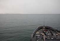 DARWIN, Northern Territory, Australia (Mar. 25, 2025) – Submarine tender USS Emory S. Land (AS 39) sails toward Darwin, Northern Territory, Australia, for a regularly scheduled port visit, Mar. 25, 2025. Darwin is Emory S. Land’s 17th port call since it departed on deployment May 17, 2024. Emory S. Land is on deployment supporting the U.S. 7th Fleet, the U.S. Navy’s largest forward deployed numbered fleet, operating with allies and partners in preserving a free and open Indo-Pacific region. (U.S. Navy photo by Mass Communication Specialist 1st Class Ian Zagrocki)