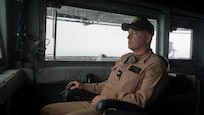 DARWIN, Northern Territory, Australia (Mar. 25, 2025) – Capt. Kenneth Holland, commanding officer of the submarine tender USS Emory S. Land (AS 39), observes from the bridge as the ship arrives in Darwin, Northern Territory, Australia for a regularly scheduled port visit, Mar. 25, 2025. Darwin is Emory S. Land’s 17th port call since it departed on deployment May 17, 2024. Emory S. Land is on deployment supporting the U.S. 7th Fleet, the U.S. Navy’s largest forward deployed numbered fleet, operating with allies and partners in preserving a free and open Indo-Pacific region. (U.S. Navy photo by Mass Communication Specialist 1st Class Ian Zagrocki)