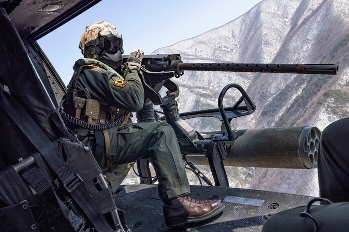 U.S. Marine Corps Cpl. Tristan Walker, a helicopter crew chief with Marine Light Attack Helicopter Squadron (HMLA) 267, Marine Aircraft Group 36, 1st Marine Aircraft Wing, sights in on an M2 machine gun during a simulated close air support (SIMCAS) exercise during Korean Marine Exchange Program 25.1, in South Korea, March 11, 2025. SIMCAS are training exercises to provide ground combat with aerial support. KMEP is a semi-annual exercise that provides iterative opportunities for Republic of Korea Marine Corps and U.S. Marine Corps units to train together, improving their combined capabilities to deter threats and maintain peace on the Korean Peninsula. (U.S. Marine Corps photo by Lance Cpl. Yanisa Culp)
