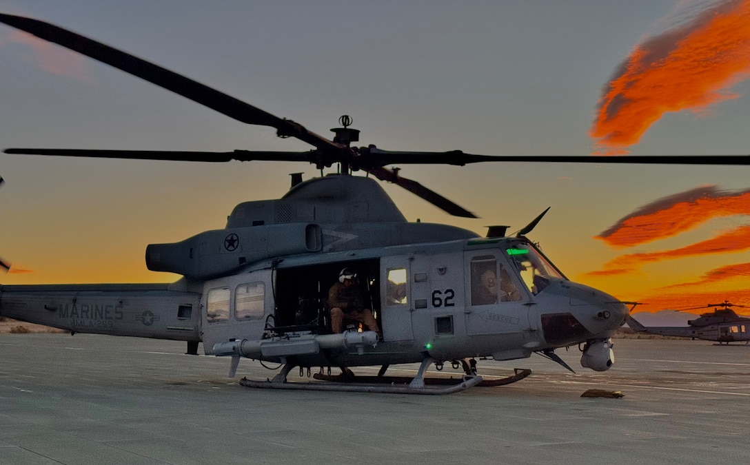A U.S. Marine Corps UH-1Y Venom assigned to Marine Light Attack Helicopter Squadron (HMLA) 269, Marine Aircraft Group 29, 2nd Marine Aircraft Wing, prepares to depart with an Intrepid Tiger II (IT-II) electronic warfare system externally attached during the 2nd Marine Aircraft Wing Service Level Training Exercise 2-25 at Marine Corps Air Ground Combat Center, Twentynine Palms, California, Feb. 20, 2025. Marines with 4th SSCT led the IT-II training to enhance electronic warfare integration across the Marine Corps, preparing forces for future missions in complex and contested environments. (U.S. Marine Corps photo by 2nd Lt. Brianna Tribou)