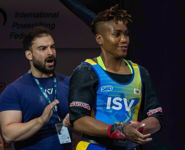 Two people in image, Todman at right at an event while second person cheers her on.