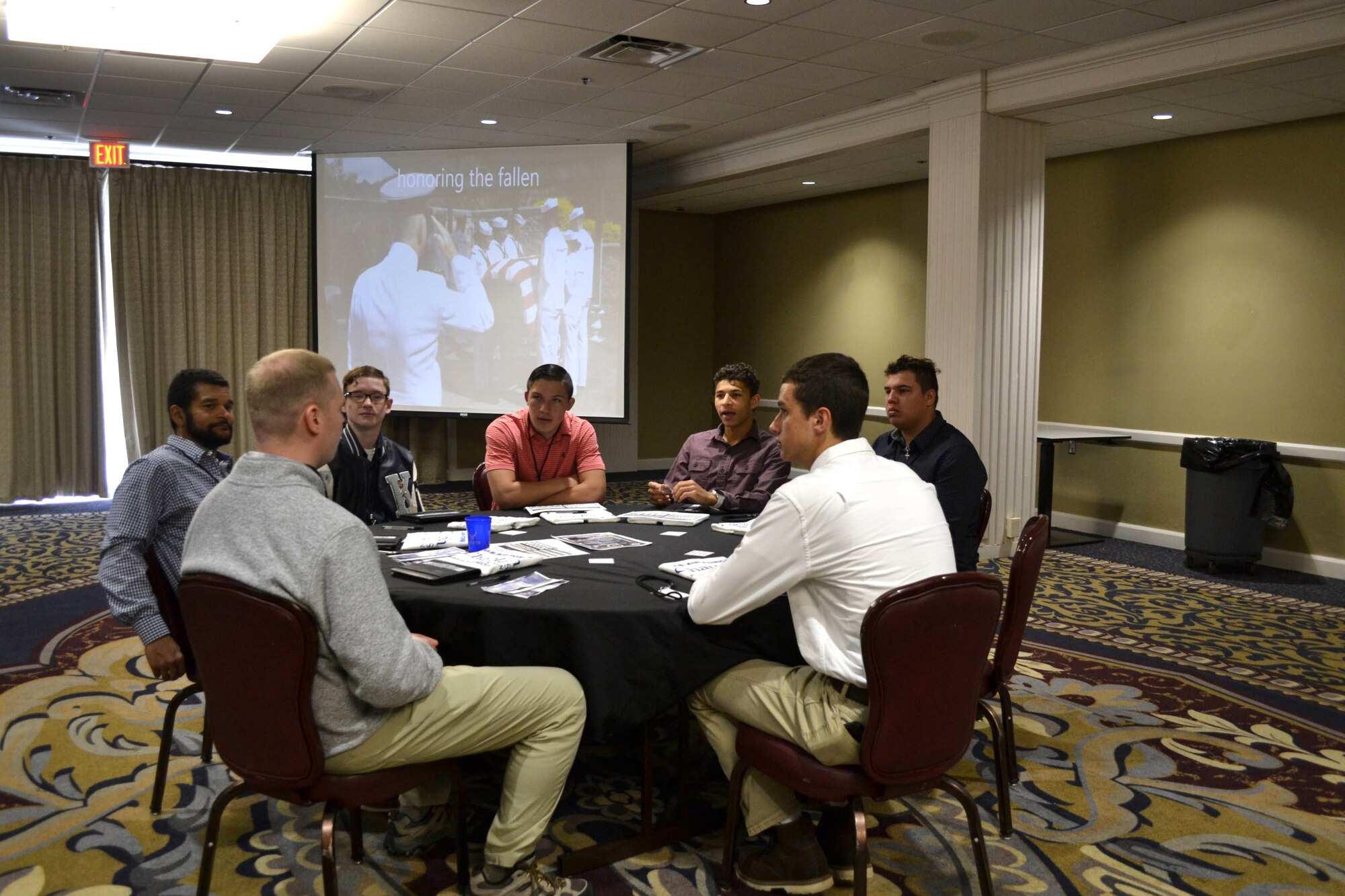 Group of men talking at table