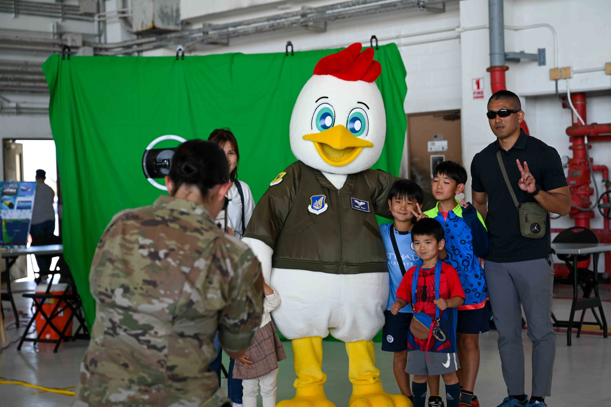 Guests take a photo of Kappy the mascot for Kadena Air Base