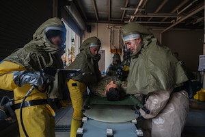 Members of the 8th Health Care Operations Squadron execute decontamination procedures during exercise Freedom Shield 25.