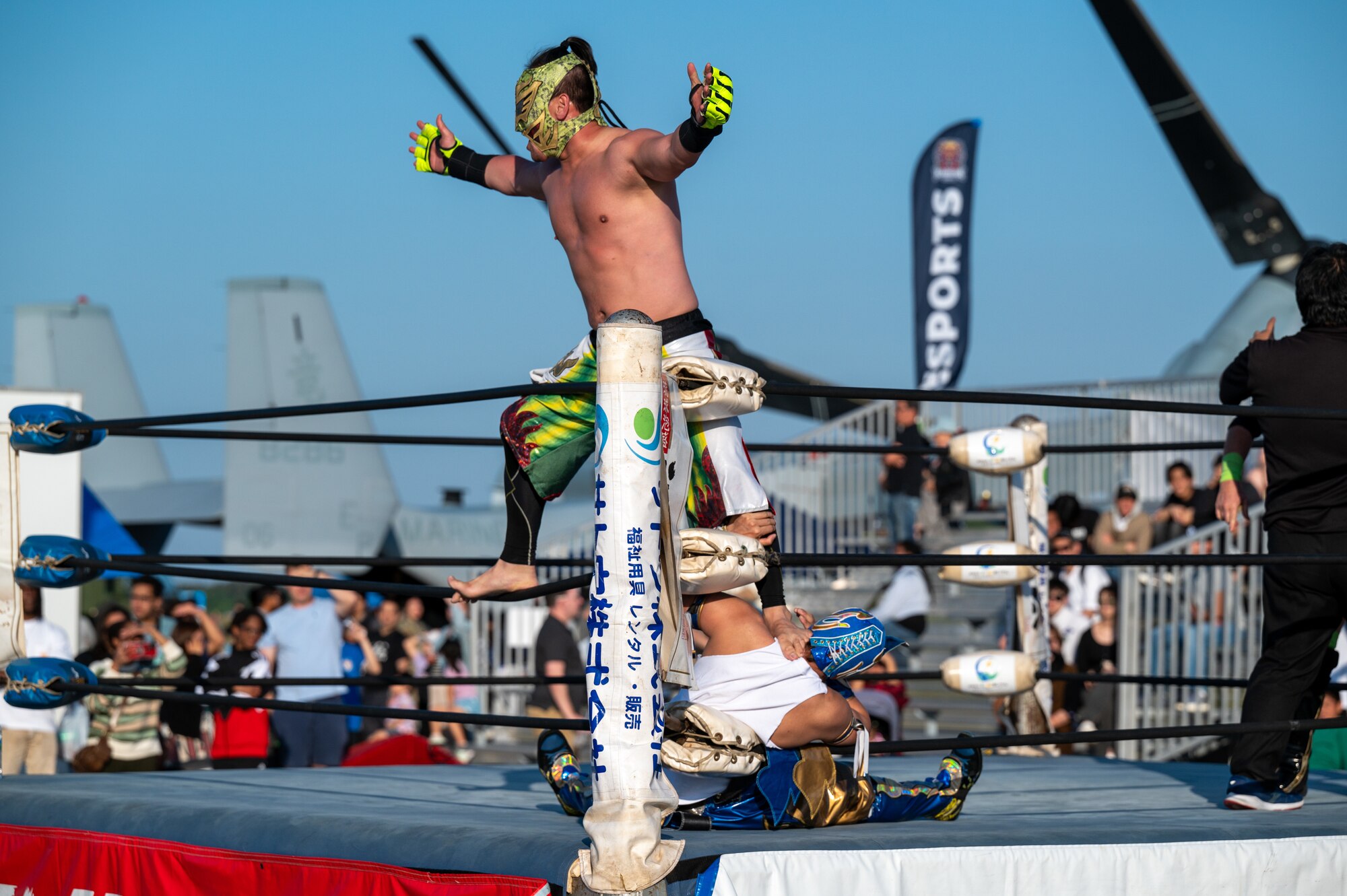 A wrestler is on the ring with another wrestler.