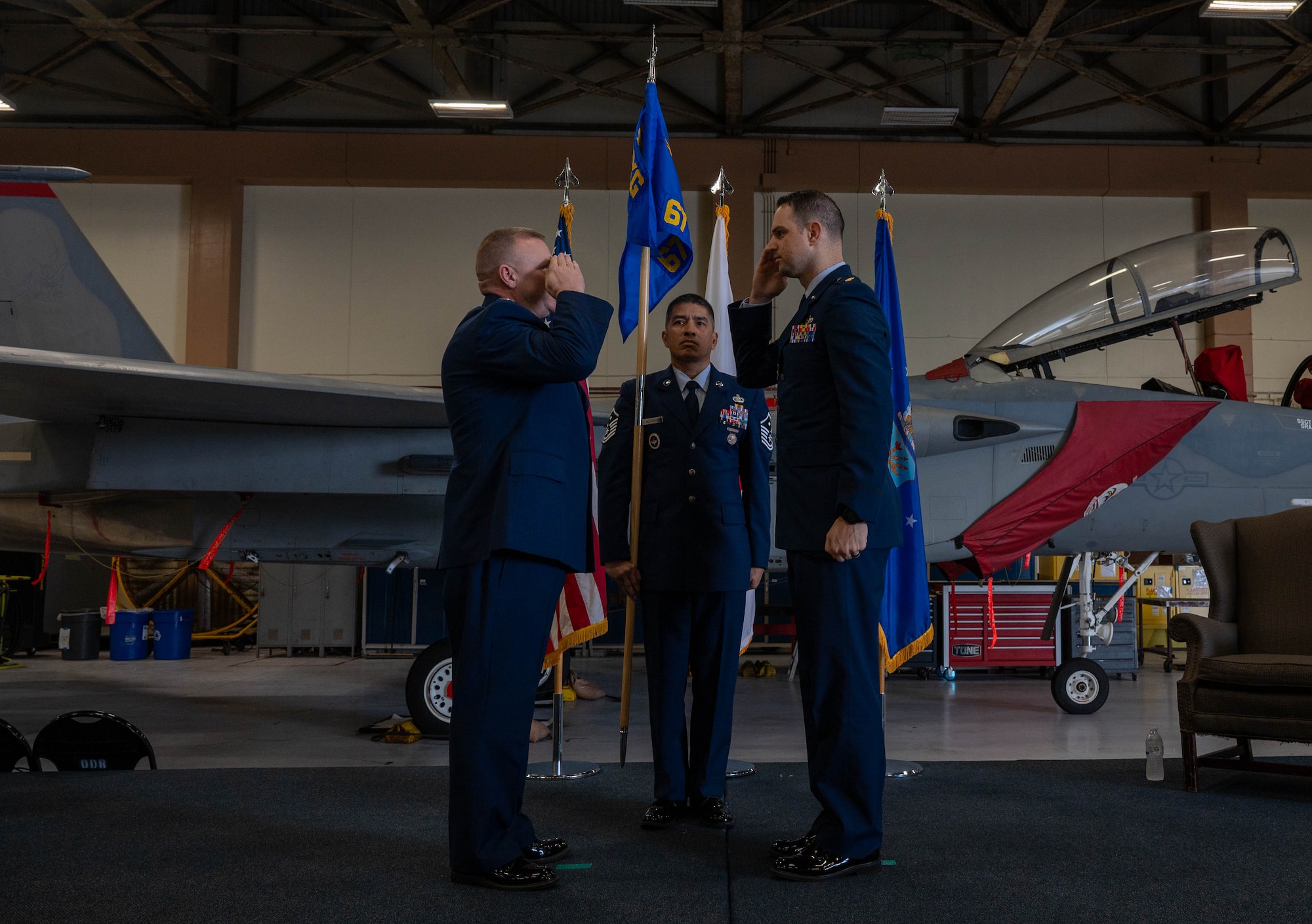 Service members salute each other.