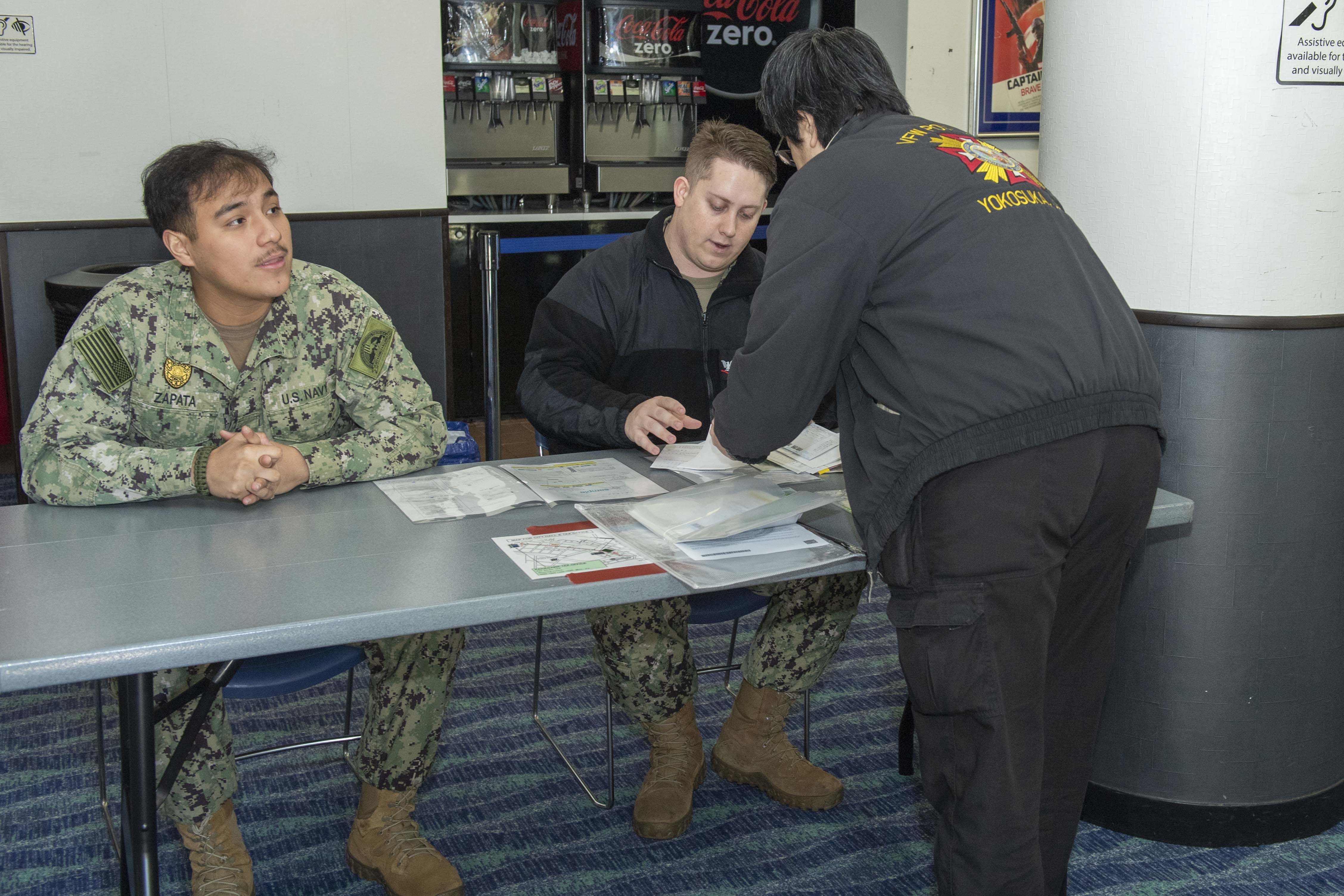 Sailors and community members onboard Commander, Fleet Activities Yokosuka (CFAY) participate in the courtesy on-base road tax campaign hosted by CFAY‘s Security Department at the Fleet Theater.