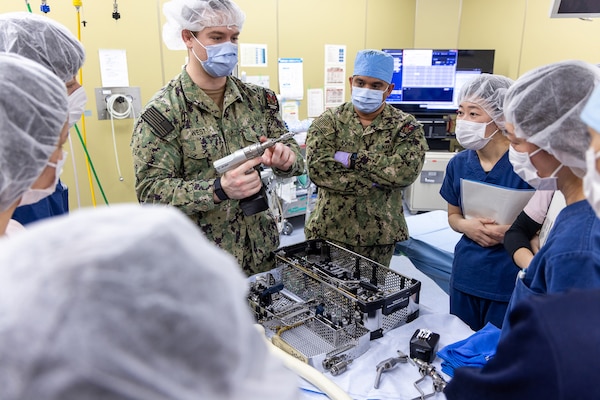 TAURA, Japan (Feb 27, 2025) Operation Room (OR) Staff Lt. Cmdr. Carlos Ochoa,Hospital Corpsman HN Gregory West provided the surgical materials for support and liaised with Japan Self-Defense Force (JSDF) OR support staff. Japan Self-Defense Force (JSDF) Hospital Yokosuka and U. S. Navy Medicine Readiness and Training Command (NMRTC) Yokosuka personnel conduct surgical training during a joint disaster response drill. The exercise focused on enhancing hospital administrative and command staff capabilities between NMRTC Yokosuka and JSDF Hospital Yokosuka in the event of a large-scale natural disaster, such as a major earthquake. It also provided an opportunity for U.S. and Japanese medical teams to improve emergency response capabilities through collaborative triage and surgical training. (U.S. Navy photo by Ai Hazama/USNMRTC Yokosuka Public Affairs)