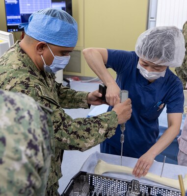 TAURA, Japan (Feb 27, 2025) Operation Room (OR) Staff Lt. Cmdr. Carlos Ochoa,Hospital Corpsman HN Gregory West provided the surgical materials for support and liaised with Japan Self-Defense Force (JSDF) OR support staff. Japan Self-Defense Force (JSDF) Hospital Yokosuka and U. S. Navy Medicine Readiness and Training Command (NMRTC) Yokosuka personnel conduct surgical training during a joint disaster response drill. The exercise focused on enhancing hospital administrative and command staff capabilities between NMRTC Yokosuka and JSDF Hospital Yokosuka in the event of a large-scale natural disaster, such as a major earthquake. It also provided an opportunity for U.S. and Japanese medical teams to improve emergency response capabilities through collaborative triage and surgical training. (U.S. Navy photo by Ai Hazama/USNMRTC Yokosuka Public Affairs)