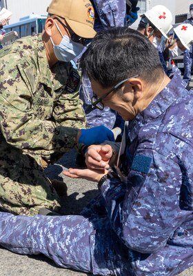 TAURA, Japan (Feb 27, 2025) Japan Self-Defense Force (JSDF) Hospital Yokosuka and U. S. Navy Medicine Readiness and Training Command (NMRTC) Yokosuka personnel conduct triage operations during a joint disaster response drill. The exercise focused on enhancing hospital administrative and command staff capabilities between NMRTC Yokosuka and JSDF Hospital Yokosuka in the event of a large-scale natural disaster, such as a major earthquake. It also provided an opportunity for U.S. and Japanese medical teams to improve emergency response capabilities through collaborative triage and surgical training. (U.S. Navy photo by Ai Hazama/USNMRTC Yokosuka Public Affairs)