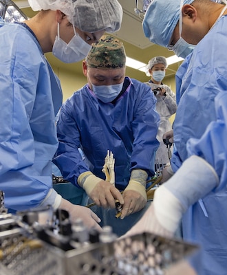 TAURA, Japan (Feb 27, 2025) Lead orthopedic surgeon, Cmdr. Benjamin Chi performs a spanning external fixation from pelvis to ankle procedure using a Hoffman III External Fixation system on a custom-made lower extremity training model during a joint disaster response drill for Japan Self-Defense Force (JSDF) Hospital Yokosuka and U. S. Navy Medicine Readiness and Training Command (NMRTC) Yokosuka. The exercise focused on enhancing hospital administrative and command staff capabilities between NMRTC Yokosuka and JSDF Hospital Yokosuka in the event of a large-scale natural disaster, such as a major earthquake. It also provided an opportunity for U.S. and Japanese medical teams to improve emergency response capabilities through collaborative triage and surgical training. (U.S. Navy photo by Daniel Taylor/USNMRTC Yokosuka Public Affairs)