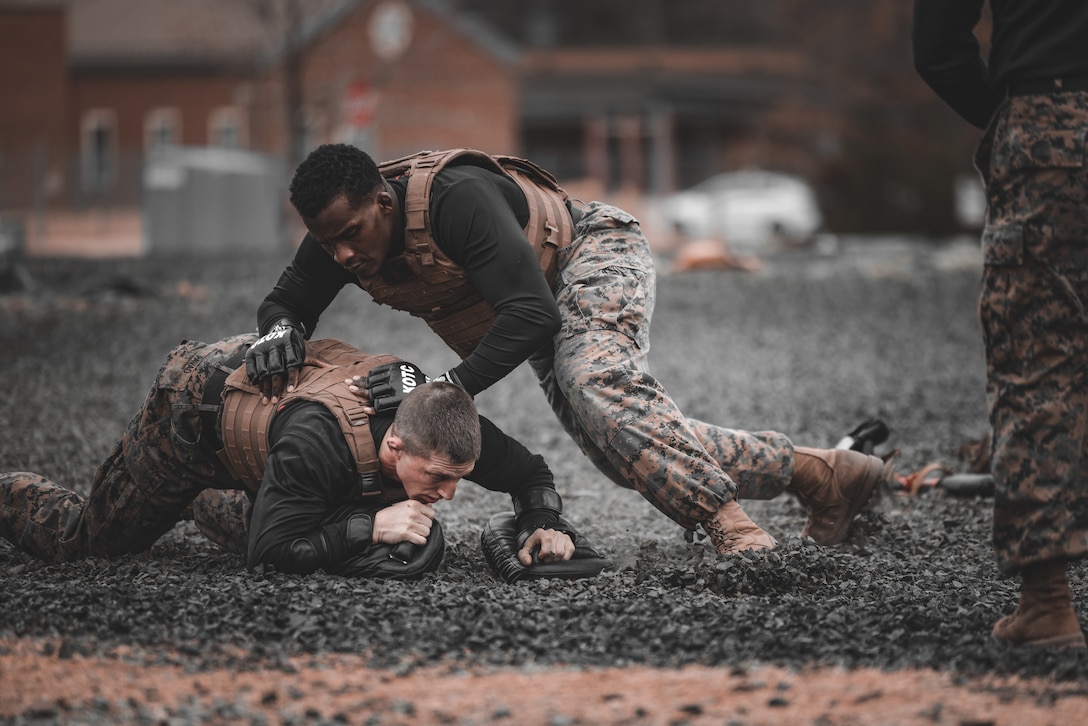 U.S. Marine Corps Gunnery Sgt. Jack Pavao, martial arts instructor trainer, and Sgt. Ar’kel Brown, martial arts instructor trainer, conduct a Marine Corps Martial Arts Demonstration at The Basic School on Marine Corps Base Quantico, Virginia, March 14, 2025. The Marine Corps Martial Arts Program aims to enhance Marines' warfighting capabilities, boost self-confidence, esprit de corps, and foster a warrior ethos, focusing on physical, mental, and moral resilience. (U.S. Marine Corps photo by Lance Cpl. Ethan Miller)