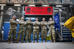 Six Airmen pose for a photo.