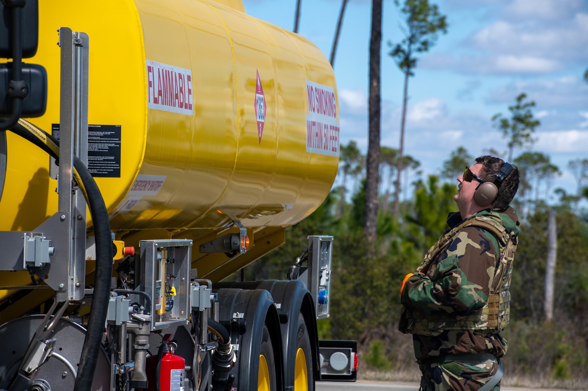 An Airman monitors fuel being pumped into an aircraft