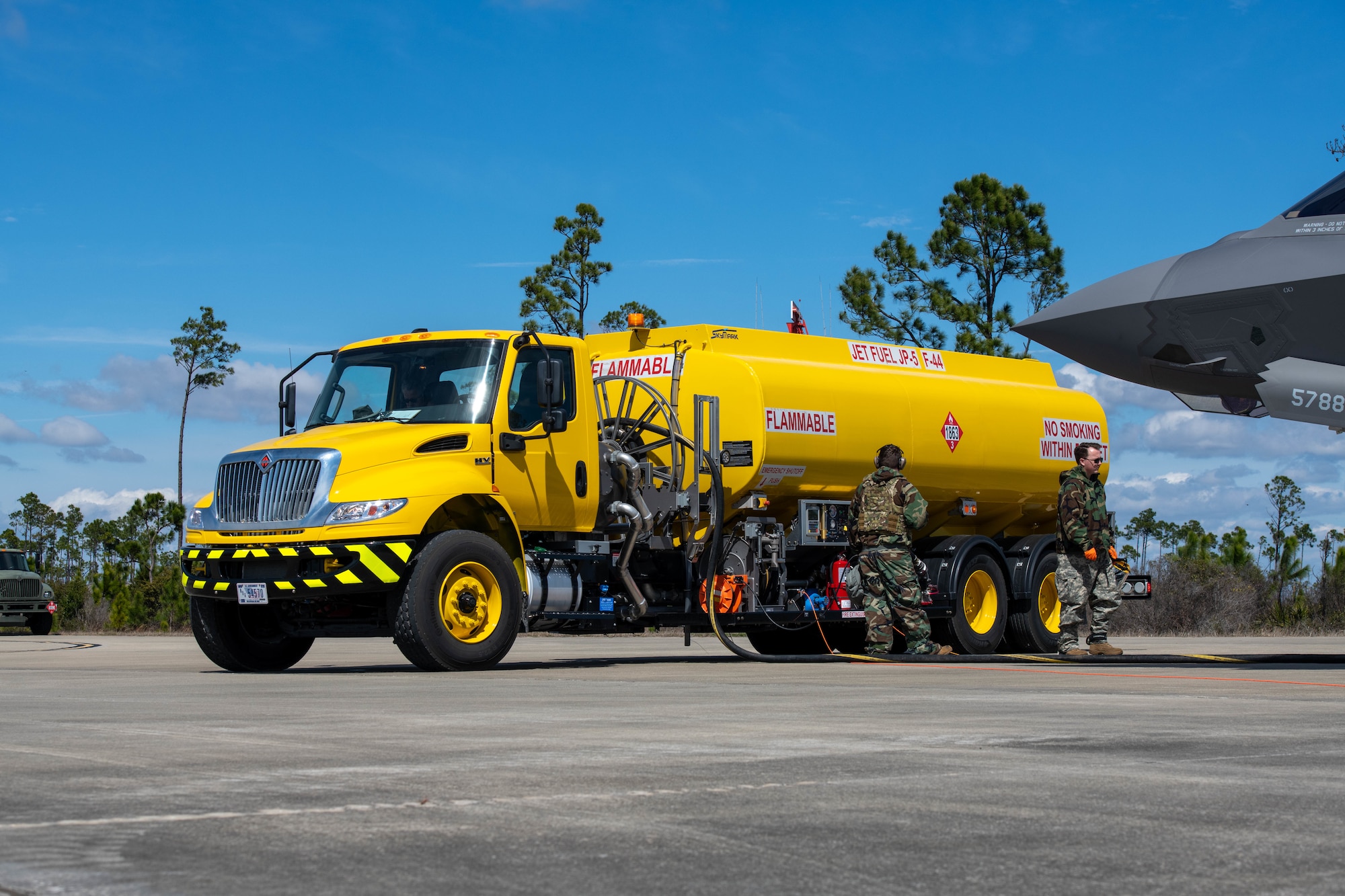 An Airman pumps fuel into an aircraft