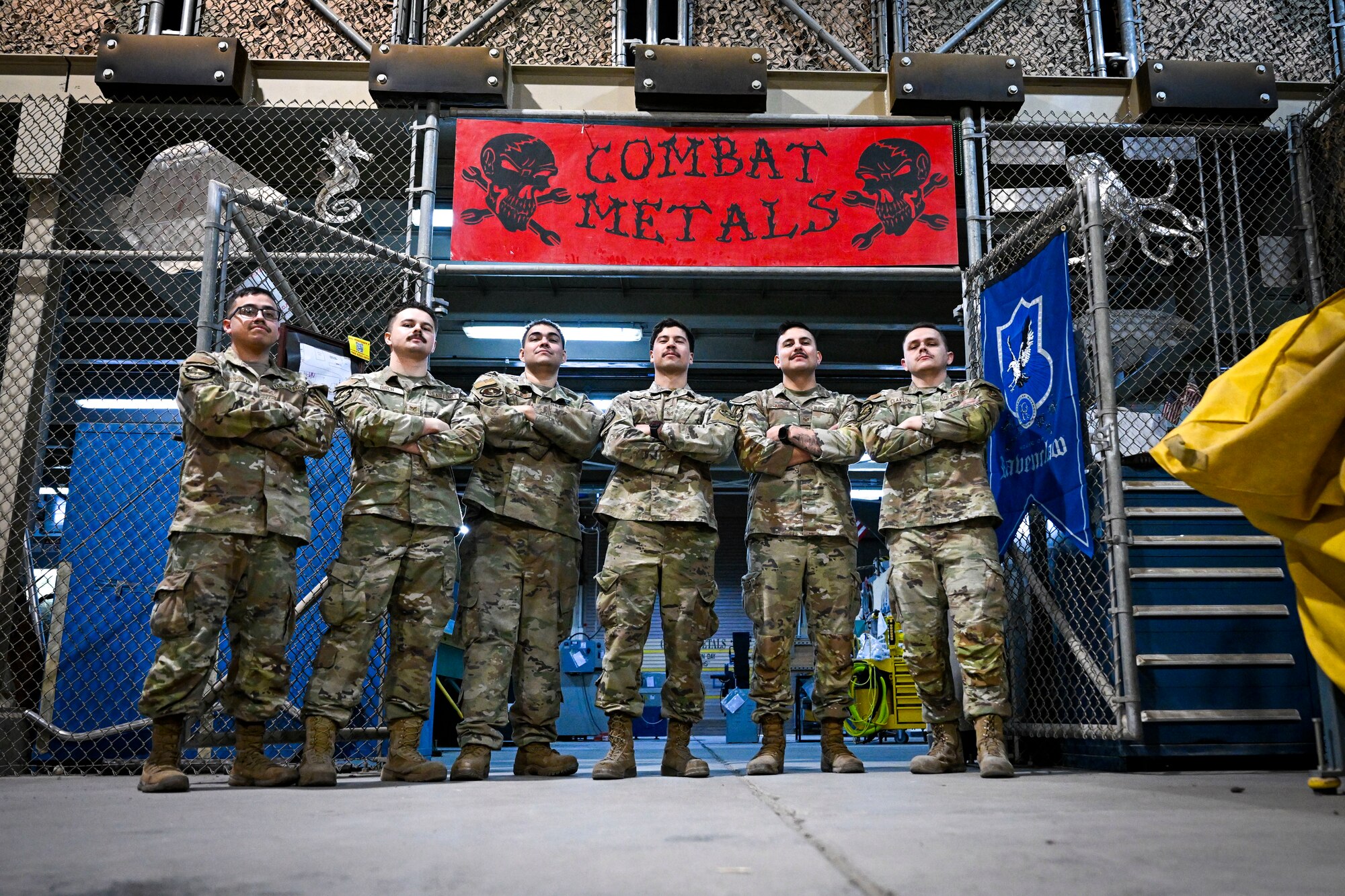 Six Airmen pose for a photo.