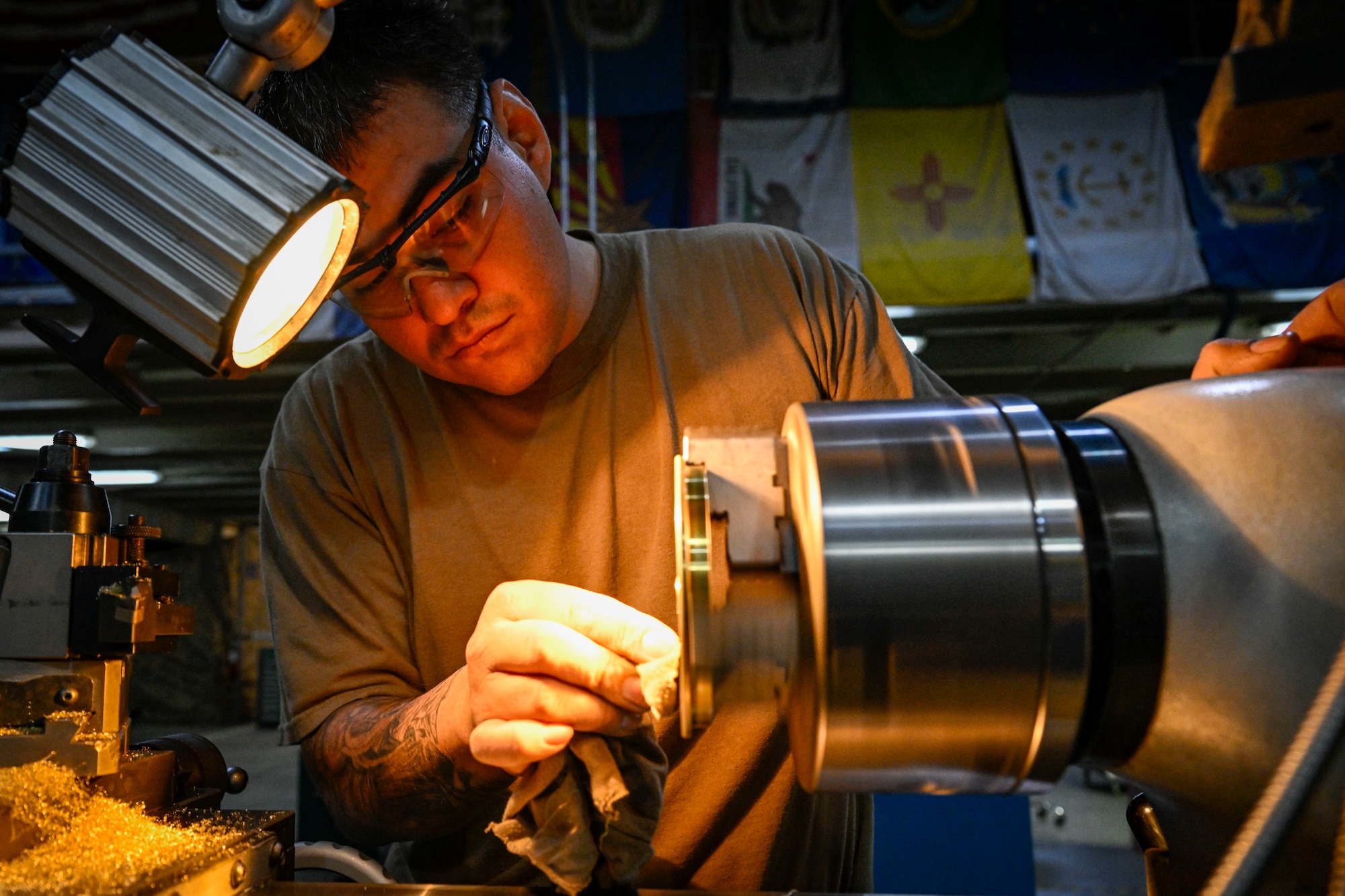 An Airman polishes a piece of equipment.