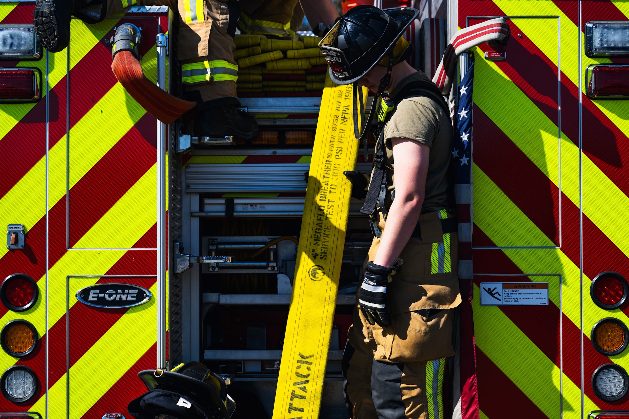 Gavin Bullard secures fire hoses during a combat readiness exercise.