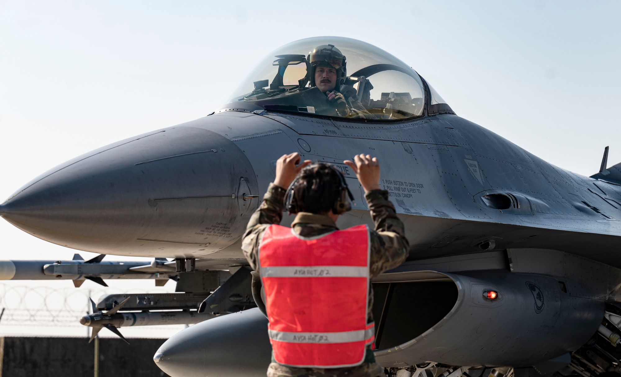 man signaling to pilot