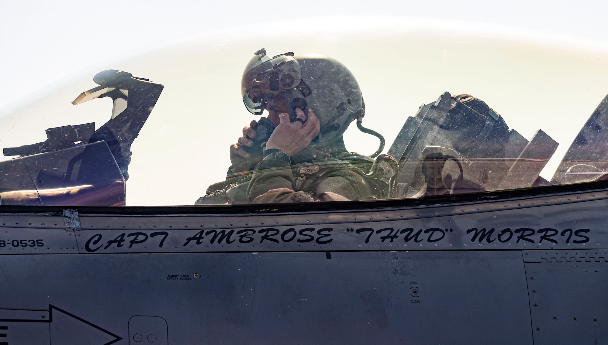 pilot putting on helmet