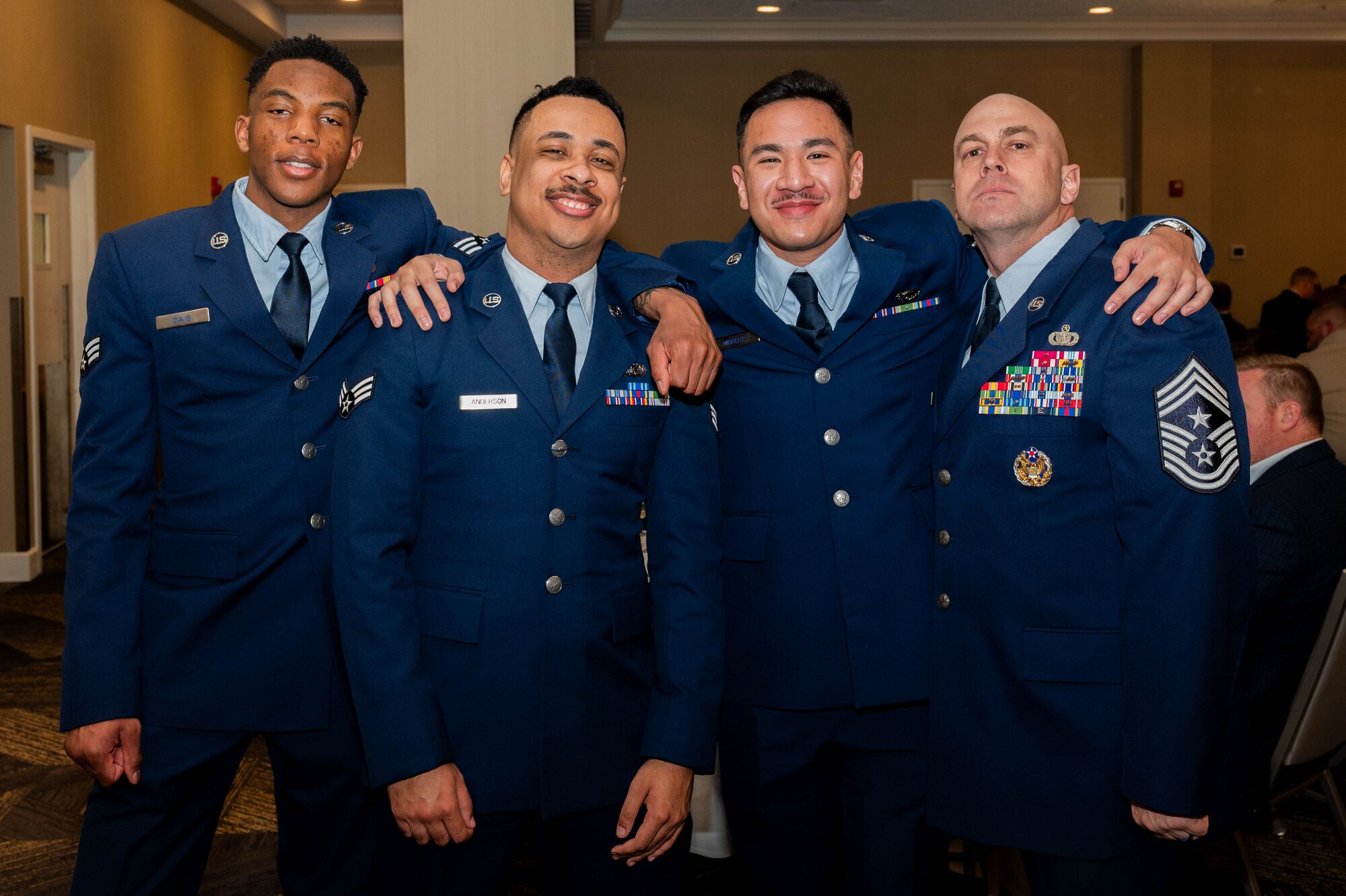 U.S. Air Force Chief Master Sgt. Shawn Andrews, 375th Air Mobility Wing command chief, along with three Airmen pause for a photo during a celebration of 75 years of community partnership at the Belle-Scott Enlisted Dinnerat the St. Clair Country Club, Belleville Illinois, March 20, 2025. The dinner was attended by Airmen from the 375th AMW and the Belleville community to celebrate the bond that the base shares with the local community. (U.S. Air Force photo by Senior Airman Shelby Rapert)