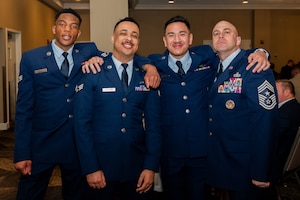 U.S. Air Force Chief Master Sgt. Shawn Andrews, 375th Air Mobility Wing command chief, along with three Airmen pause for a photo during a celebration of 75 years of community partnership at the Belle-Scott Enlisted Dinnerat the St. Clair Country Club, Belleville Illinois, March 20, 2025. The dinner was attended by Airmen from the 375th AMW and the Belleville community to celebrate the bond that the base shares with the local community. (U.S. Air Force photo by Senior Airman Shelby Rapert)
