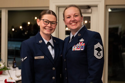 Airmen from the 375th Air Mobility Wing pose for a photo at the 75th Belle-Scott Enlisted Dinner at the St. Clair Country Club, Belleville Illinois, March 20, 2025. The dinner was attended by Airmen from the 375th AMW and the Belleville community to celebrate the bond that the base shares with the local community. (U.S. Air Force photo by Senior Airman Shelby Rapert)
