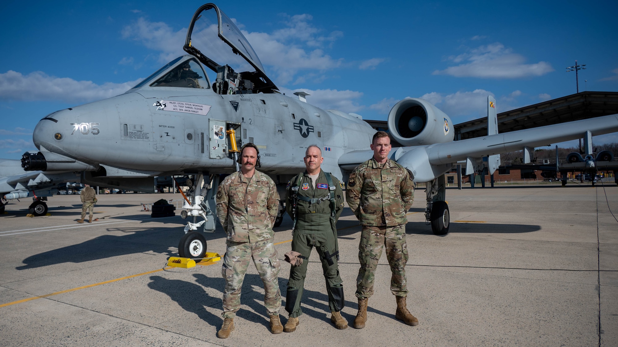 Maryland Air National Guard Lt. Col. Steven Montalvo, 175th Wing inspector general and A-10 pilot for the 104th Fighter Squadron, Master Sgt. Christipher Kelley, superintendent for the 175th Command Post and former crew chief, and Tech. Sgt. John McCulloch, crew chief for the 175th Aircraft Maintenance Squadron, pose for a photo in front of the A-10C Thunderbolt II aircraft 705 at Warfield Air National Guard Base at Martin State Airport at Martin State Airport, Maryland, March 26, 2025.