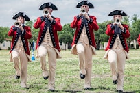 four personnel marching playing bugels