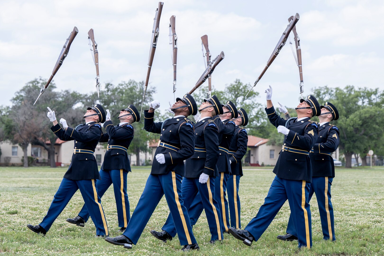 soldiers throwing rifles in air