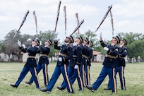 soldiers throwing rifles in air